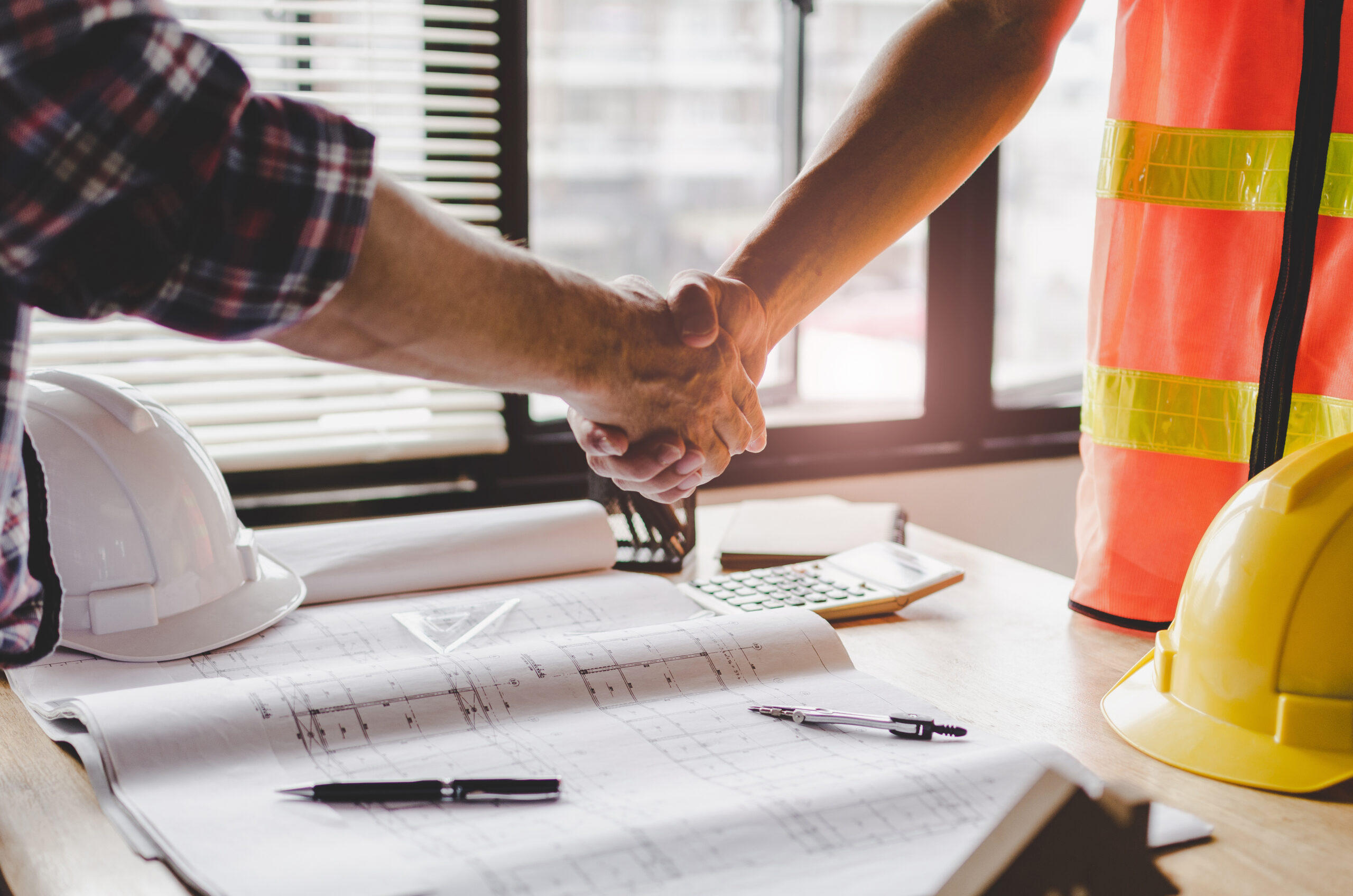 construction worker team hands shaking after consultation meetin